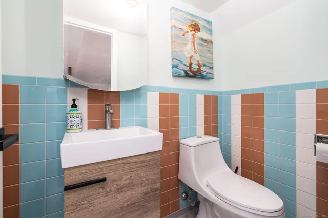 a bathroom with a sink a toilet and shower curtain
