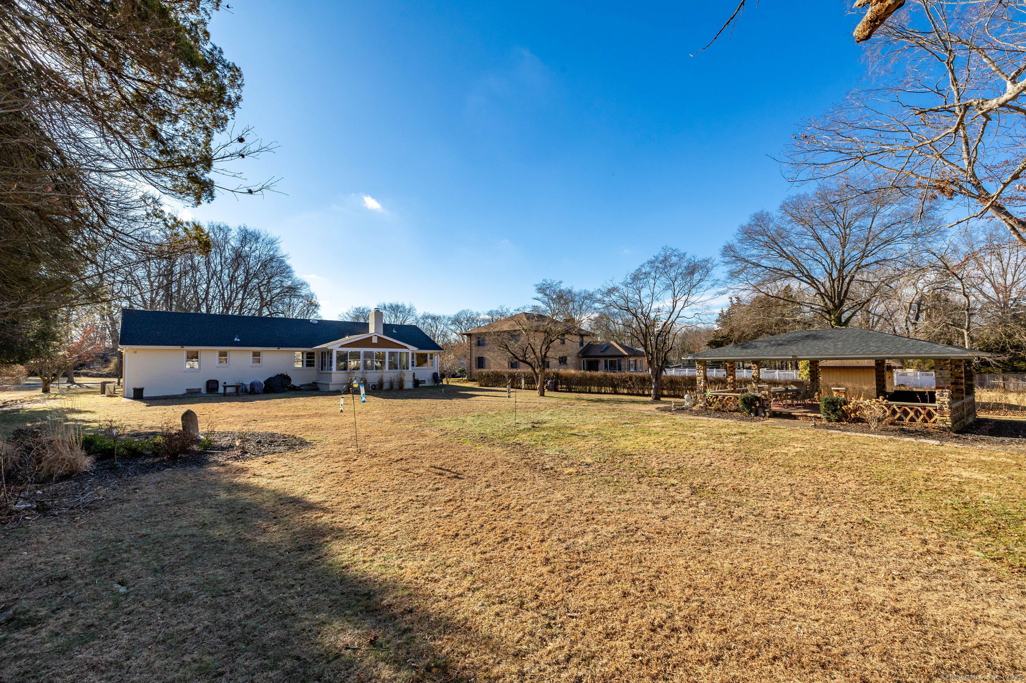 2 Columbine Lane Norwalk, CT 06851 - Photo 27 of 33 a tall yellow house with trees in front of it
