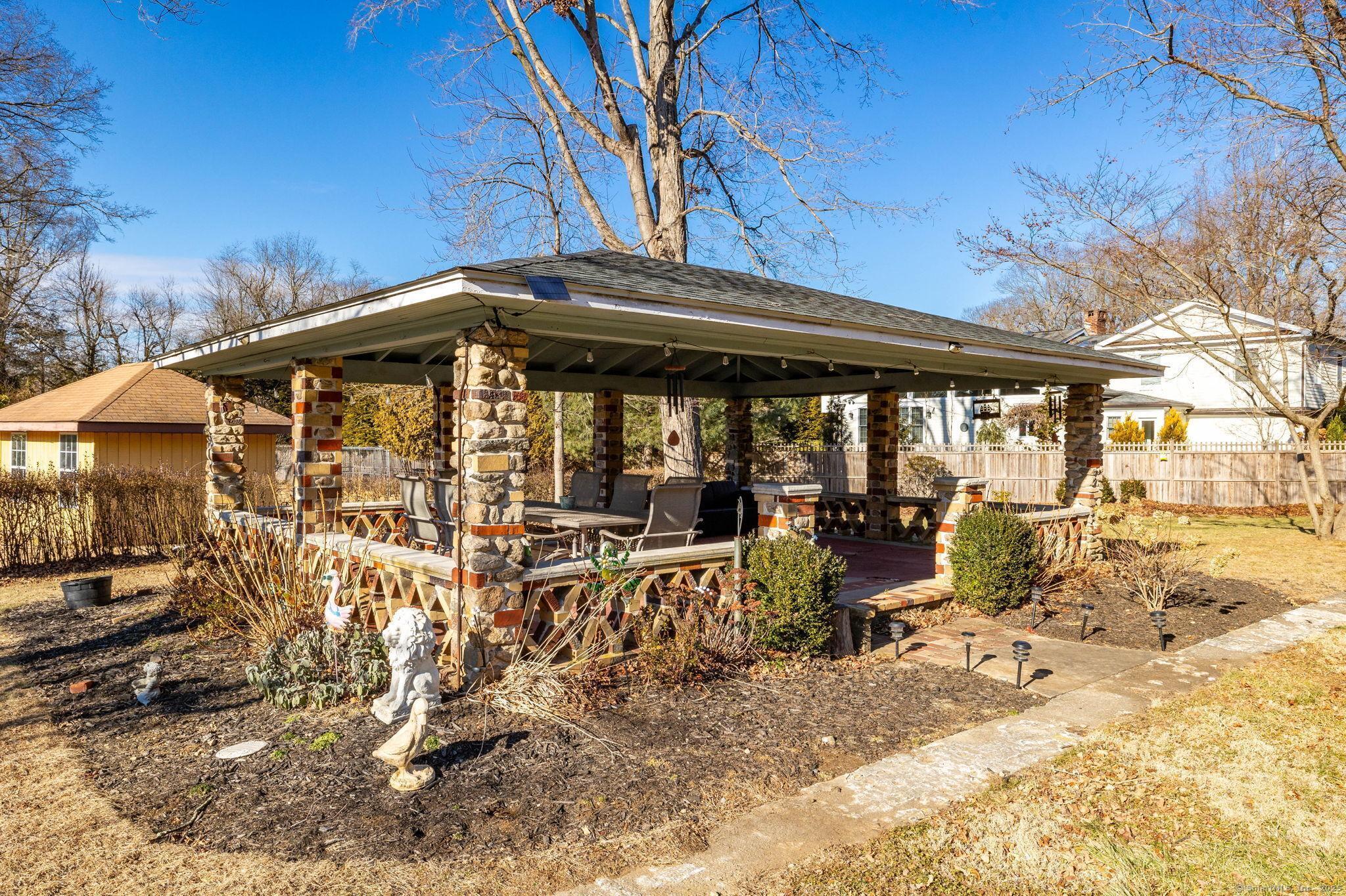 2 Columbine Lane Norwalk, CT 06851 - Photo 29 of 33 a view of a patio with wooden table and chairs