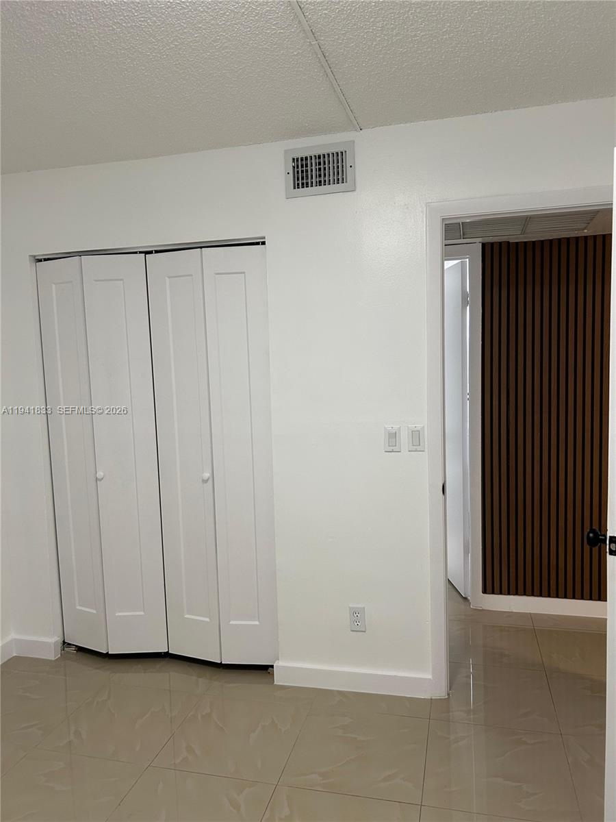 10027 Winding Lake Road, Unit 103 Sunrise, FL 33351 - Photo 8 of 11 a view of a closet area with rug