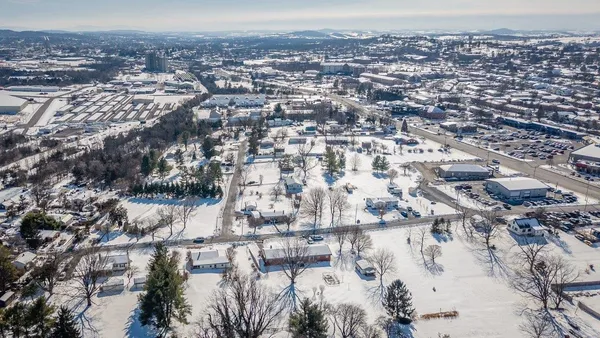 an aerial view of residential houses with outdoor space