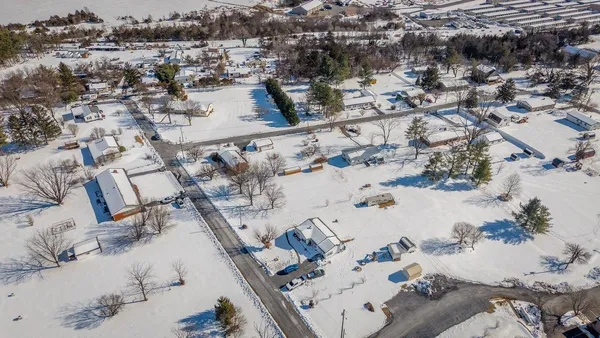 an aerial view of a house with a yard and lake view