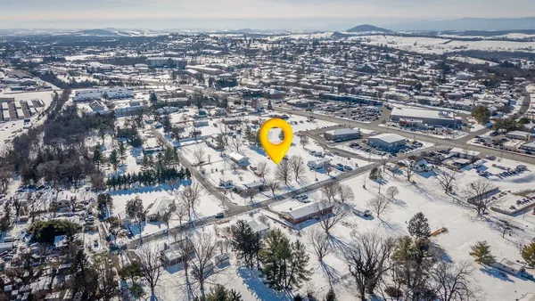 an aerial view of a house with a swimming pool