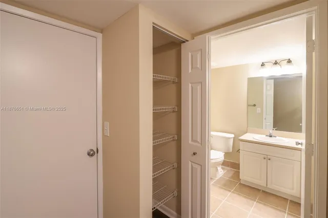 a bathroom with a granite countertop sink mirror and a bathtub