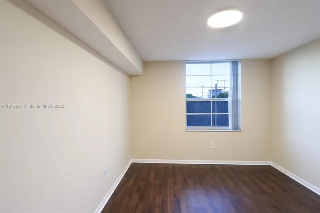 a view of a room with wooden floor and windows