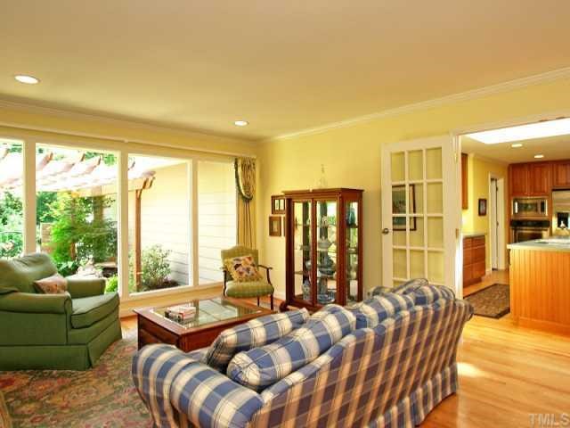2723 Fairview Road Raleigh, NC 27608 - Photo 3 of 12 a living room with furniture and a floor to ceiling window