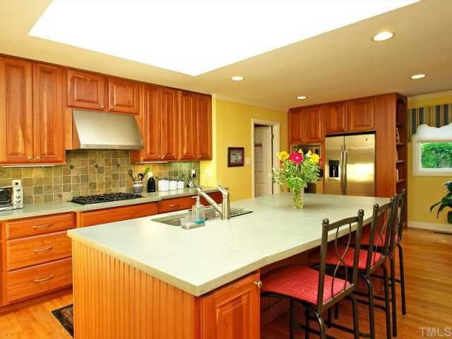 2723 Fairview Road Raleigh, NC 27608 - Photo 4 of 12 a kitchen with a sink cabinets and window