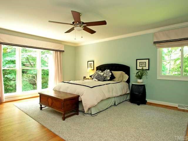2723 Fairview Road Raleigh, NC 27608 - Photo 8 of 12 a spacious bedroom with a bed and a window