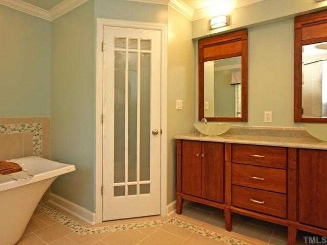 2723 Fairview Road Raleigh, NC 27608 - Photo 9 of 12 a bathroom with a sink and a mirror