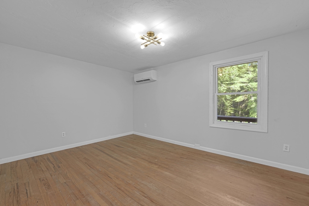65 Breakneck Road Sturbridge, MA 01566 - Photo 14 of 42 wooden floor in an empty room with a window