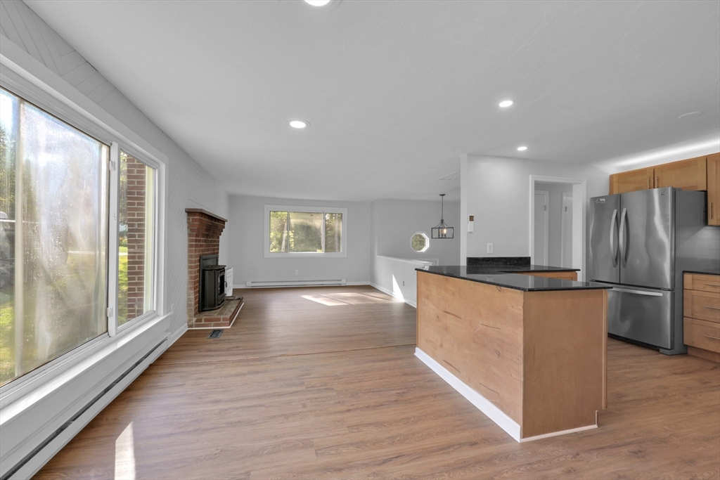 65 Breakneck Road Sturbridge, MA 01566 - Photo 8 of 42 a large kitchen with stainless steel appliances granite countertop a large counter top a refrigerator and a stove