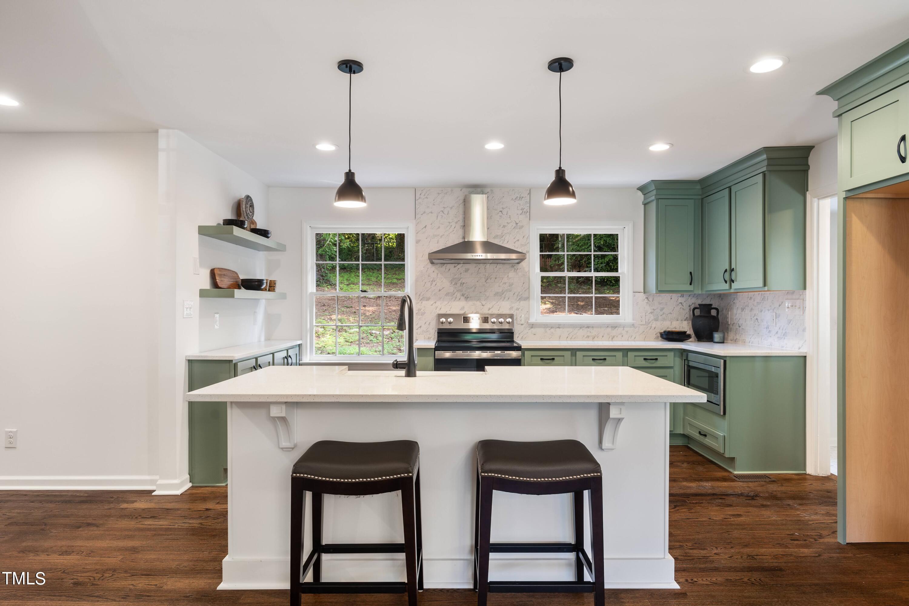 3512 Swift Drive Raleigh, NC 27606 - Photo 19 of 35 a kitchen with kitchen island a dining table and chairs