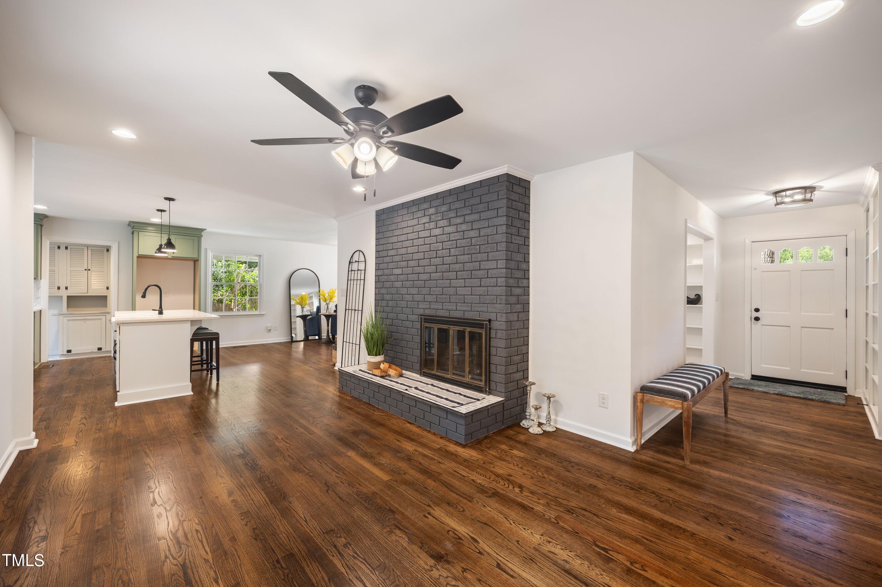 3512 Swift Drive Raleigh, NC 27606 - Photo 21 of 35 a living room with furniture wooden floor and a fireplace
