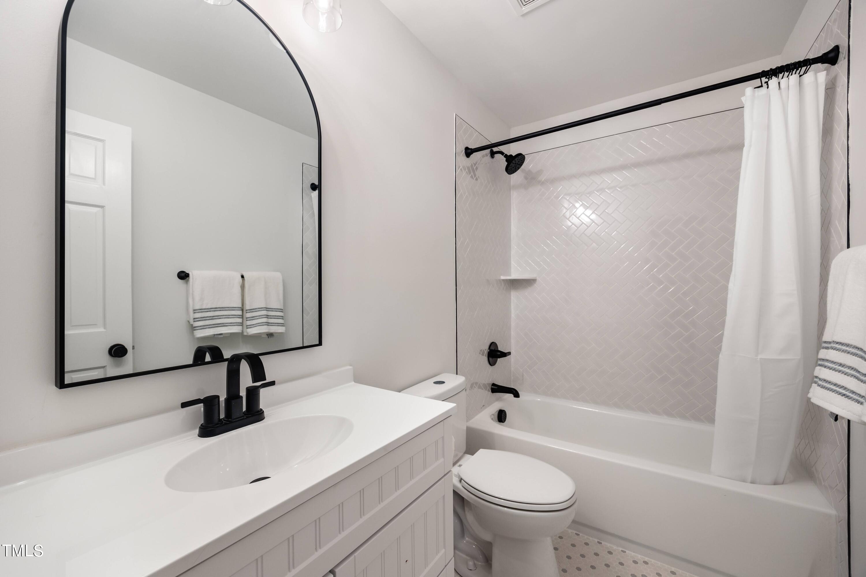 3512 Swift Drive Raleigh, NC 27606 - Photo 23 of 35 a bathroom with a sink toilet and shower