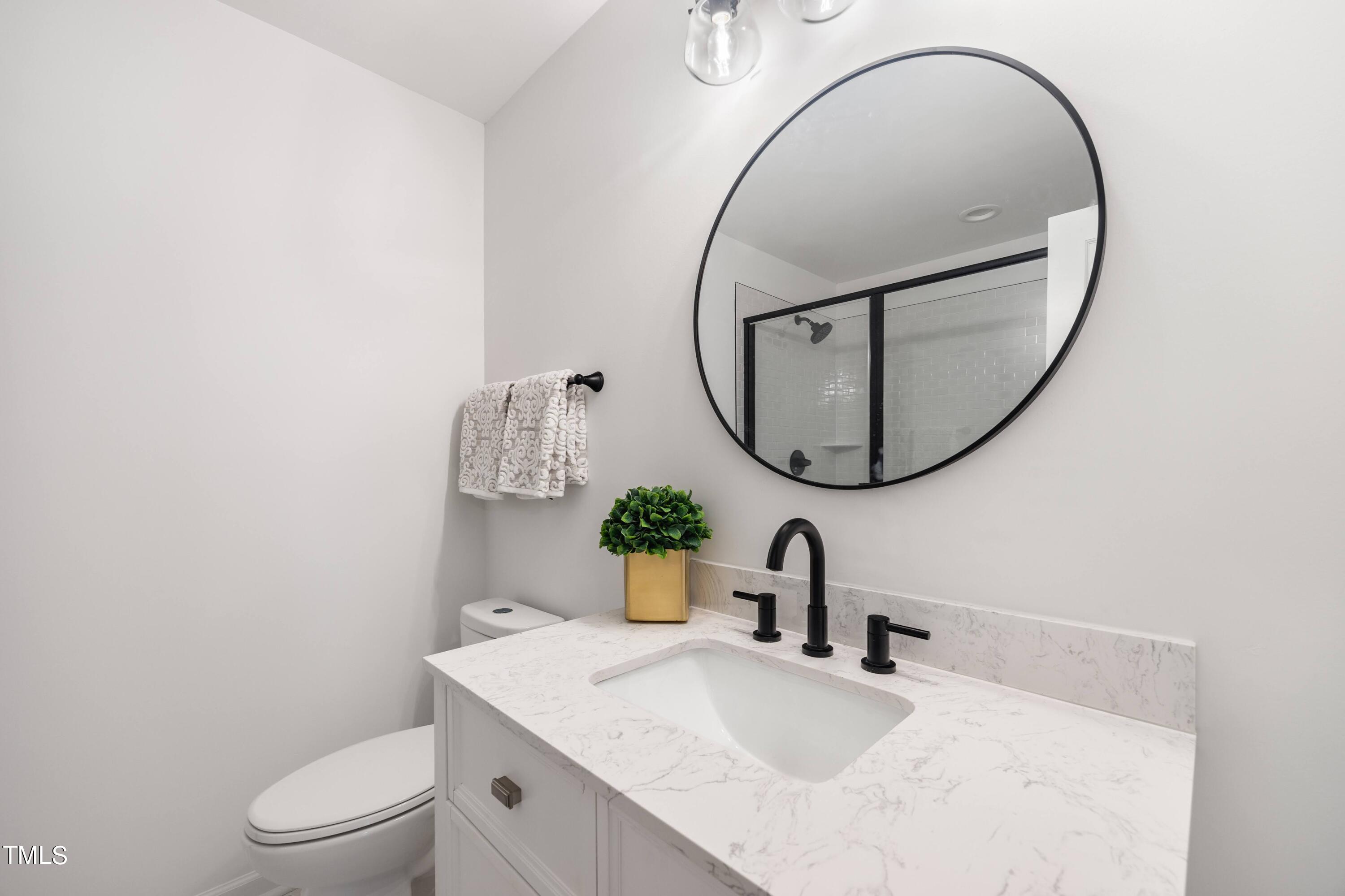 3512 Swift Drive Raleigh, NC 27606 - Photo 24 of 35 a bathroom with a sink and a mirror