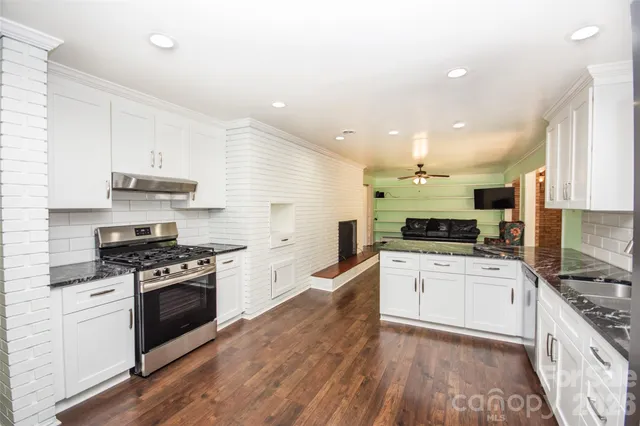 a kitchen with a stove a sink and a refrigerator