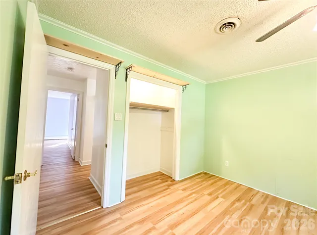 a view of a room with wooden floor and bathroom