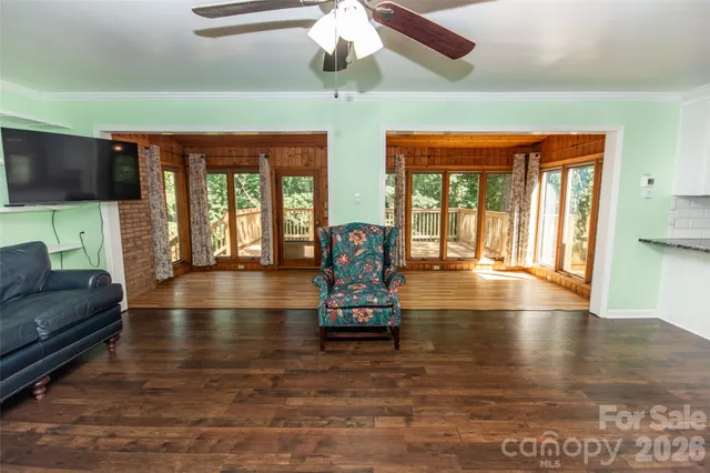 a room with lots of windows and furniture