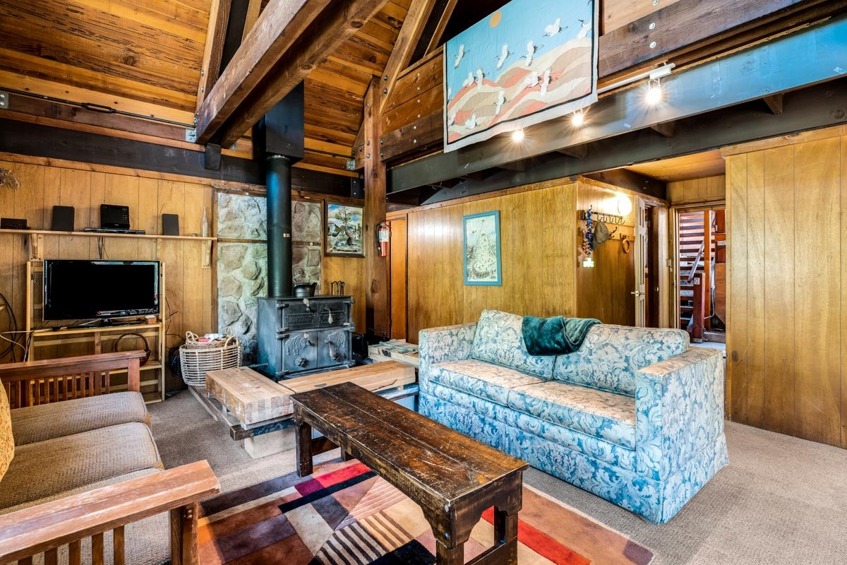 1650 Upper Bench Road Alpine Meadows, CA 96146 - Photo 6 of 21 a living room with furniture and a flat screen tv