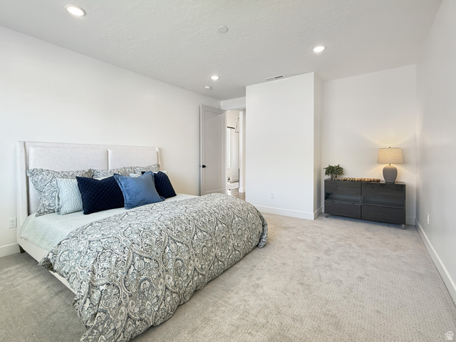916 Rocky Mountain Way Elk Ridge, UT 84651 - Photo 21 of 54 Bedroom with light colored carpet and recessed lighting