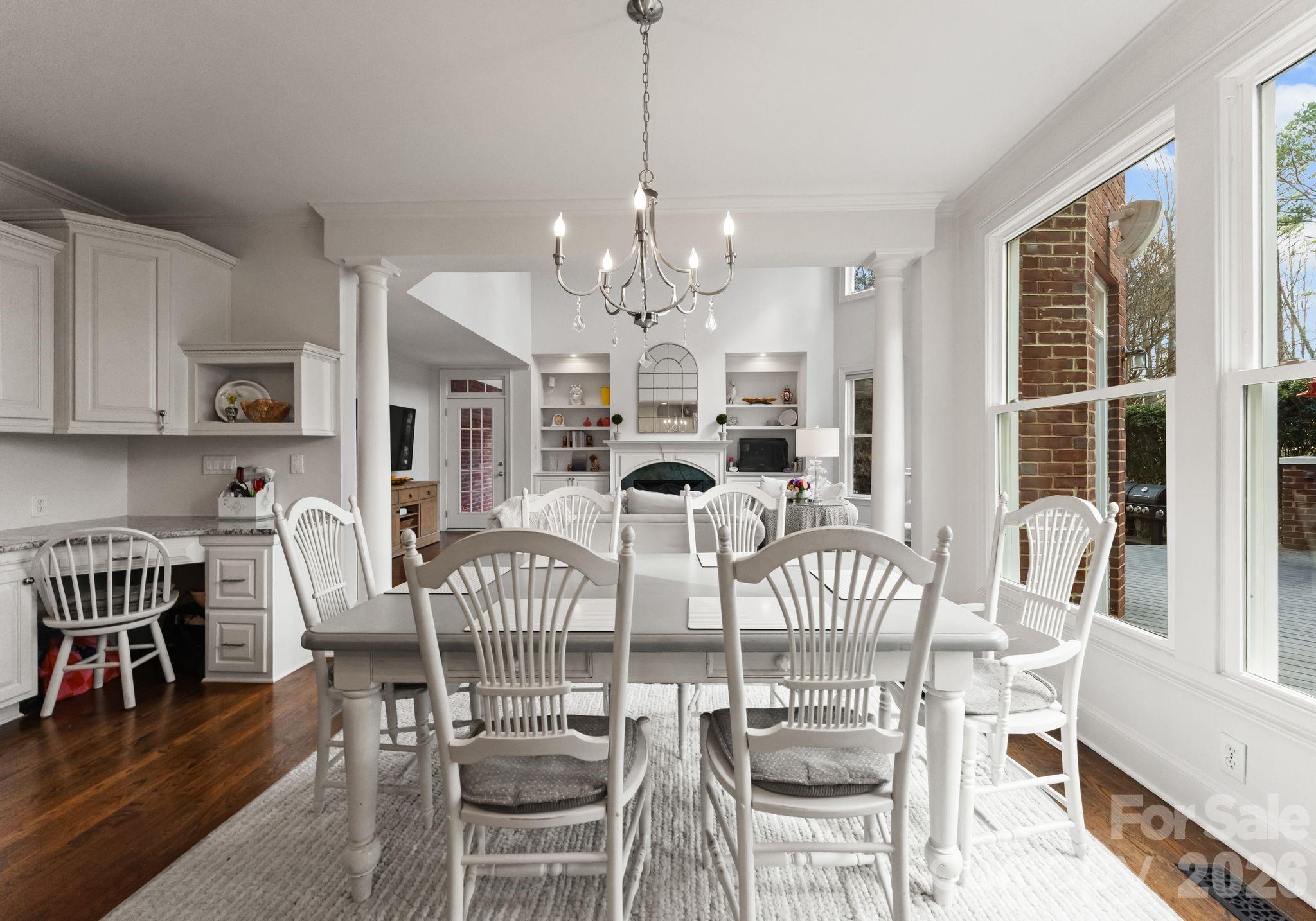 15705 Knox Hill Road Huntersville, NC 28078 - Photo 13 of 48 a view of a dining room with furniture a chandelier and wooden floor