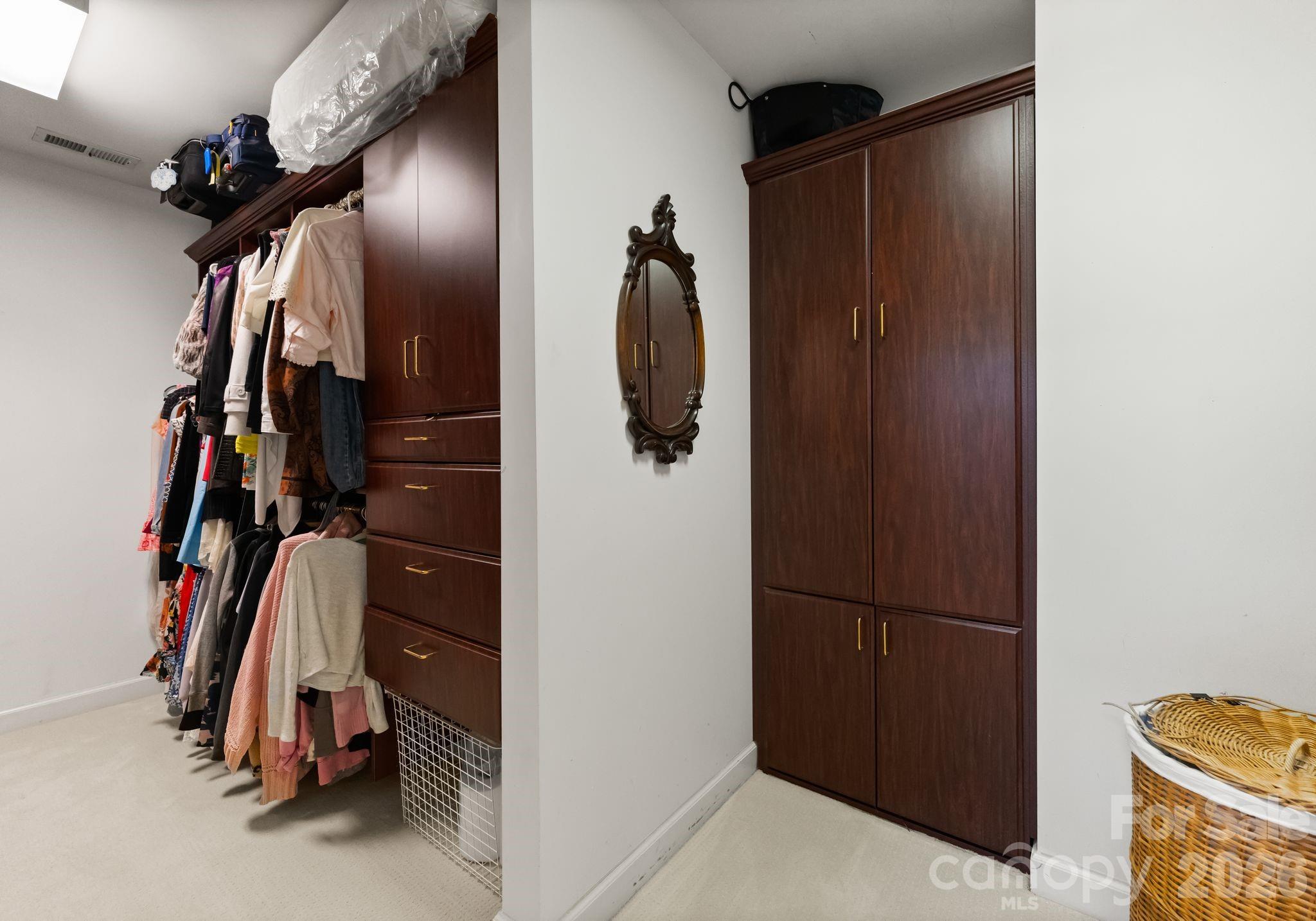15705 Knox Hill Road Huntersville, NC 28078 - Photo 25 of 48 a view of walk in closet with clothes and shoes