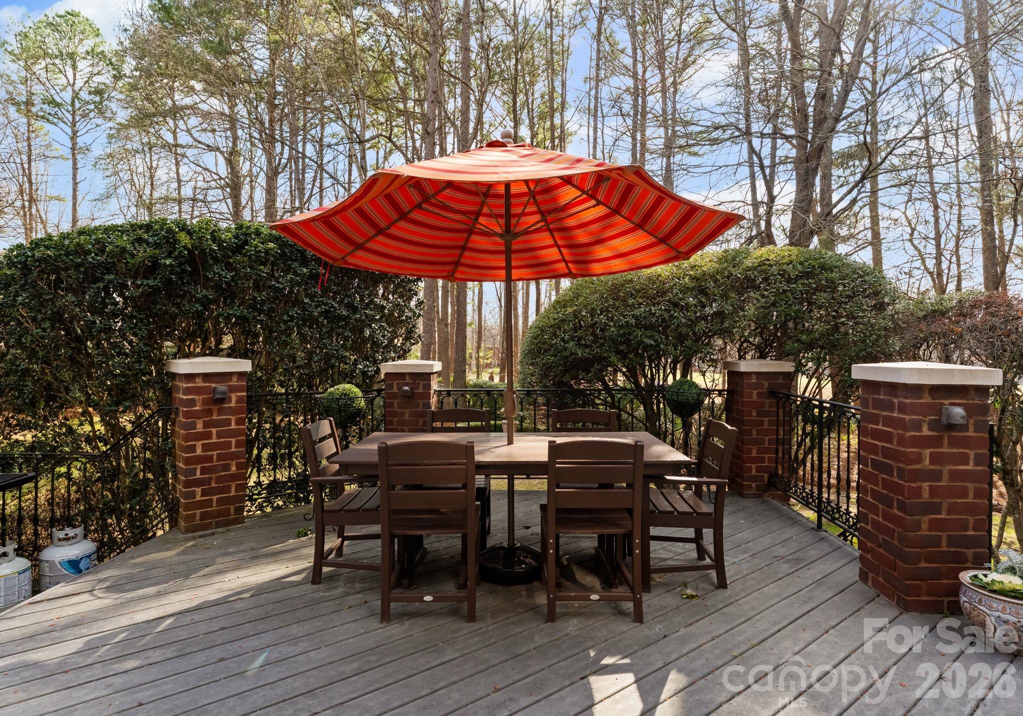 15705 Knox Hill Road Huntersville, NC 28078 - Photo 47 of 48 a view of a roof deck with table and chairs under an umbrella