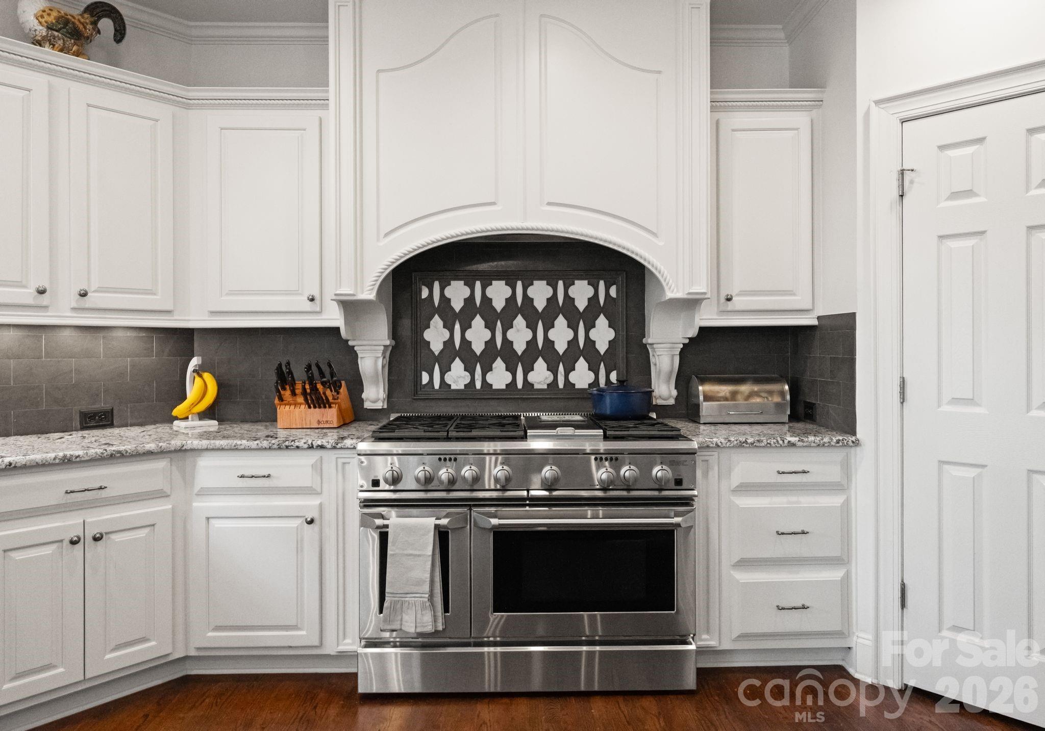 15705 Knox Hill Road Huntersville, NC 28078 - Photo 9 of 48 a kitchen with stainless steel appliances granite countertop a stove and white cabinets