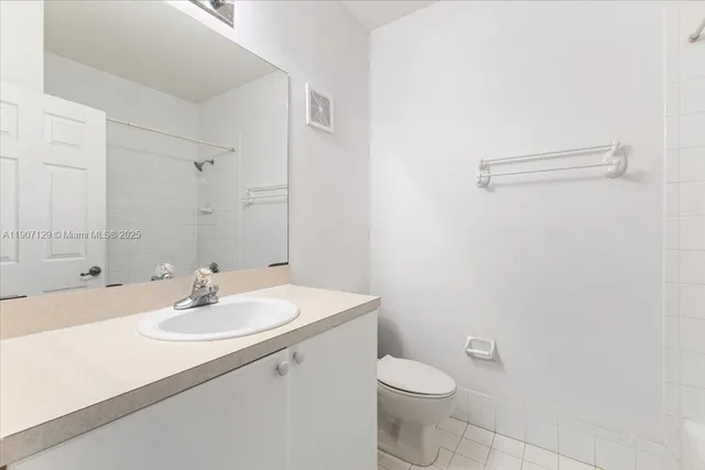 a bathroom with a sink toilet and a mirror