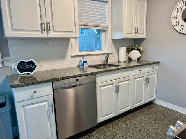 a kitchen with stainless steel appliances granite countertop a sink a stove and a microwave