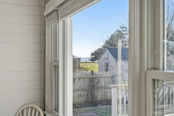 a view of a house with a yard and a wooden deck