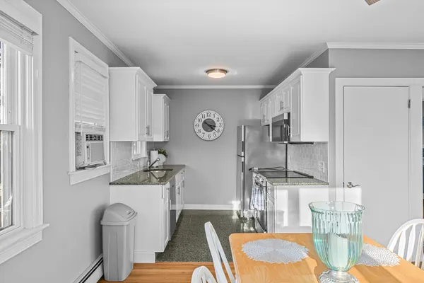 a view of a yard with a tree and a fence