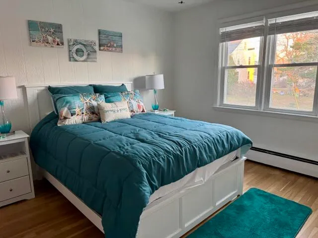 a bedroom with a bed and a window