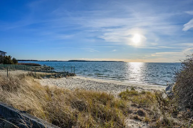 a view of a dining room with furniture a rug and wooden floor