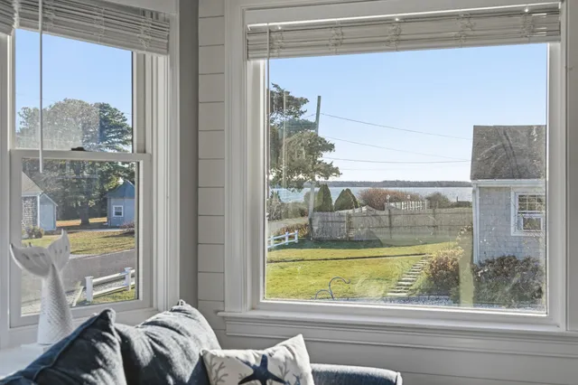a kitchen with granite countertop a sink a stove a oven and white cabinets