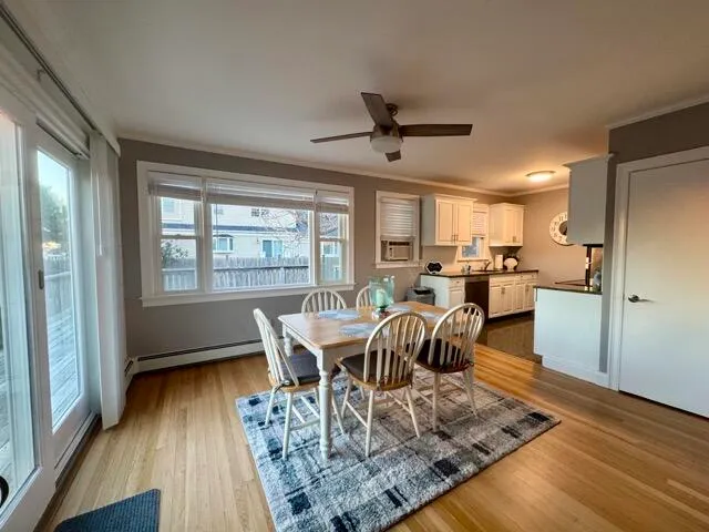 a view of a dining room with furniture window and wooden floor