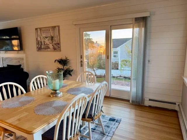 a view of a dining room with furniture window and wooden floor