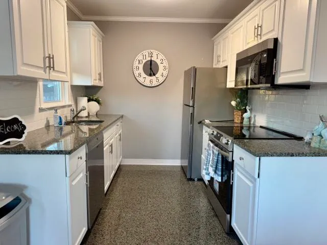 a kitchen with stainless steel appliances granite countertop a refrigerator a stove top oven a sink and dishwasher