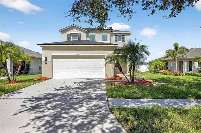 a front view of a house with a yard and garage