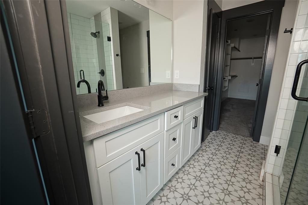 1764 Palladio Loop Princeton, TX 75407 - Photo 21 of 40 Bathroom featuring a white shaker vanity with matte black hardware, light-toned countertop, and a rectangular undermount sink with a matte black faucet