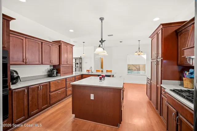 a kitchen with stainless steel appliances a sink stove and cabinets
