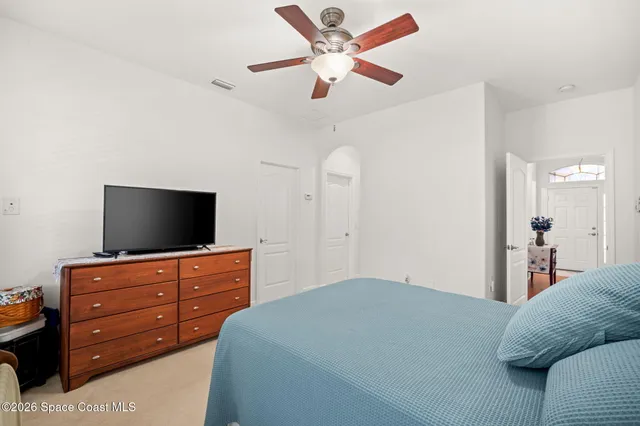 a bedroom with a bed and a flat screen tv