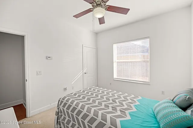 a bedroom with a bed and window