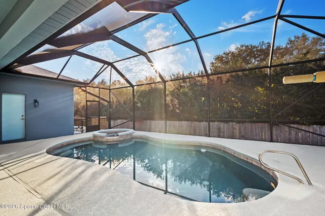 a view of a swimming pool with a outdoor seating space