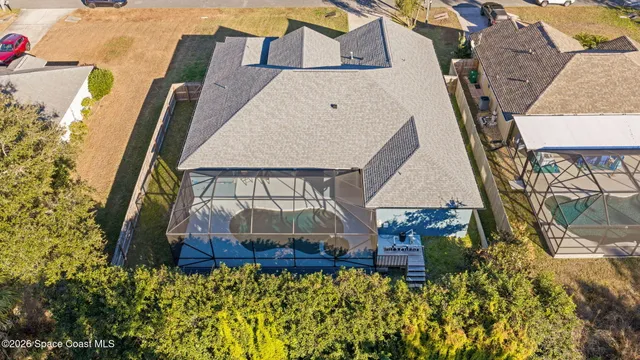 an aerial view of a house with a yard