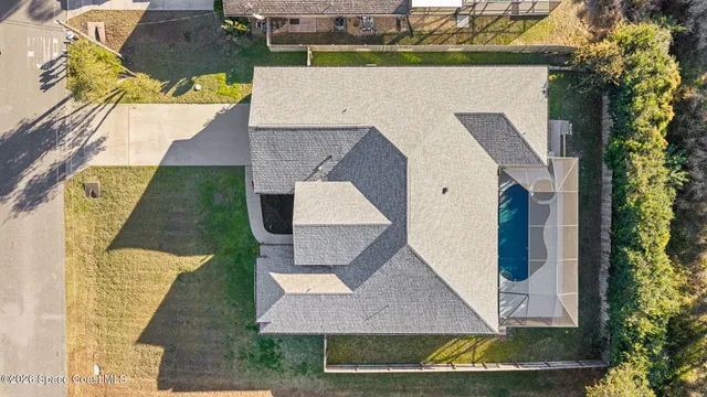 an aerial view of a house with a yard