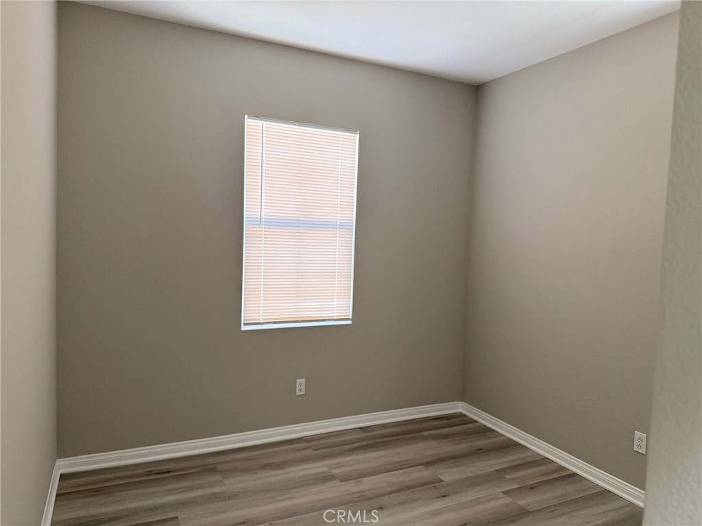 4547 Nicole Way Riverside, CA 92501 - Photo 15 of 36 an empty room with wooden floor and windows
