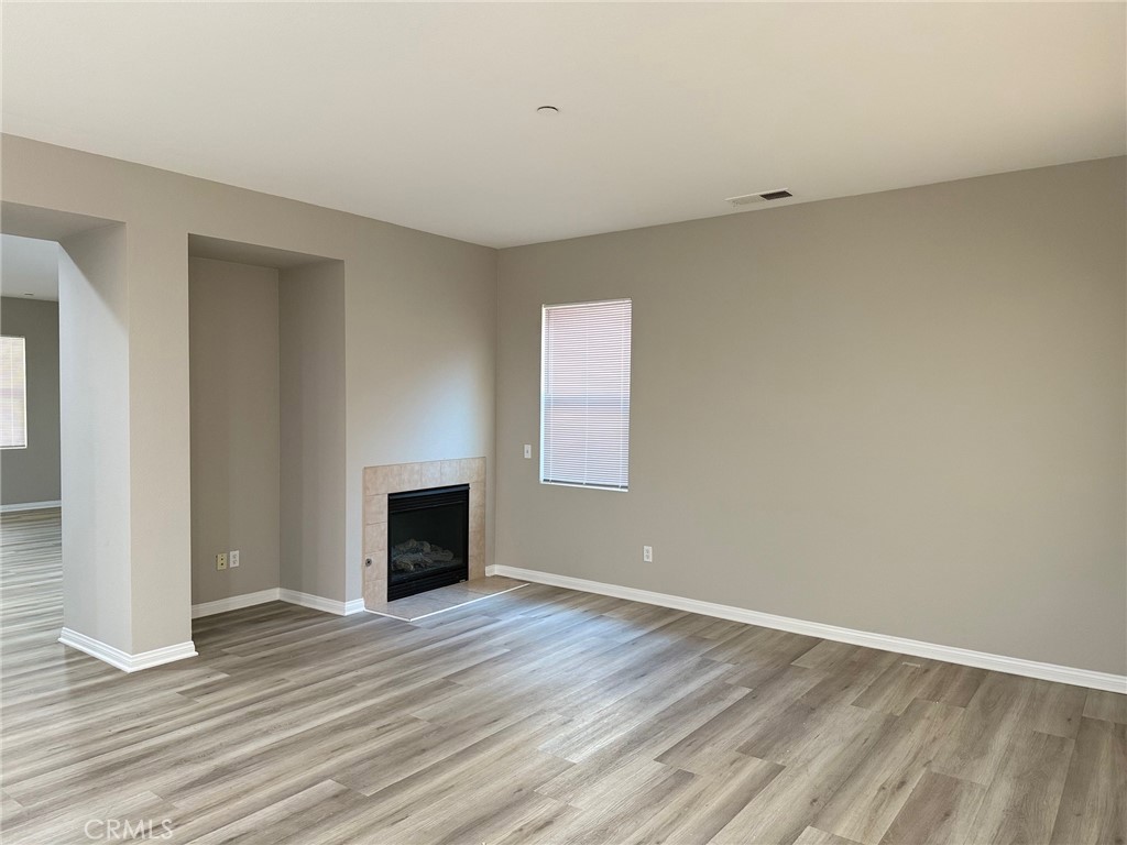 4547 Nicole Way Riverside, CA 92501 - Photo 18 of 36 wooden floor fireplace and windows in an empty room