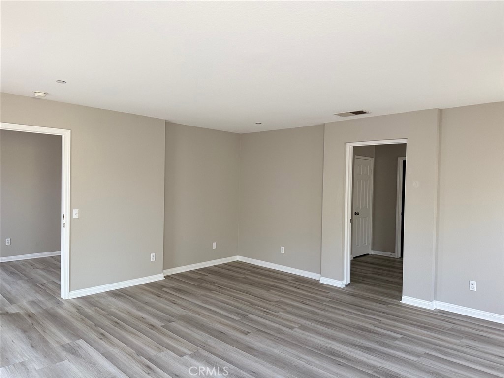 4547 Nicole Way Riverside, CA 92501 - Photo 22 of 36 a view of an empty room with wooden floor