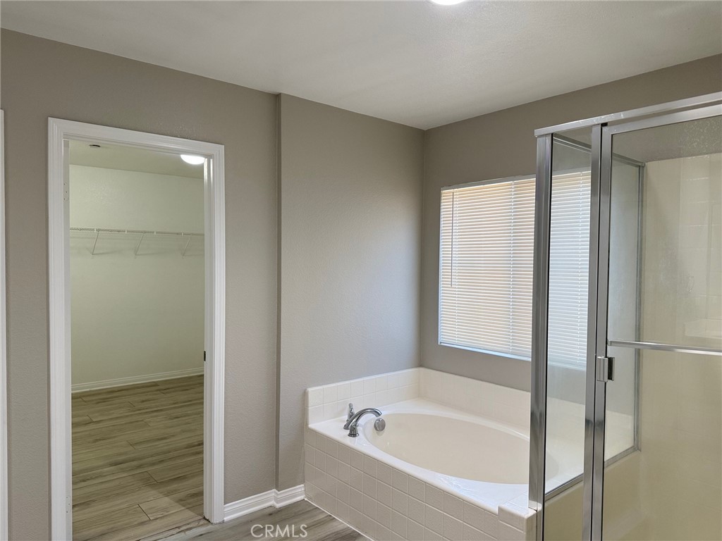 4547 Nicole Way Riverside, CA 92501 - Photo 23 of 36 a bathroom with a tub shower and a sink
